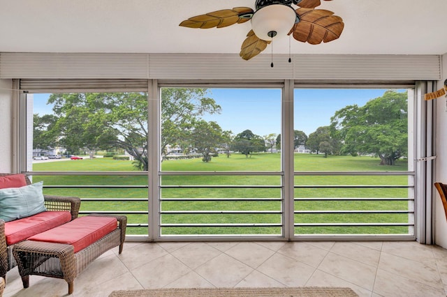 sunroom featuring ceiling fan and a wealth of natural light