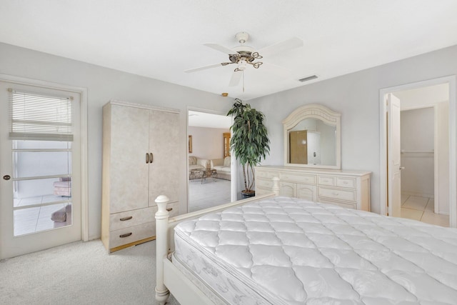 carpeted bedroom with ceiling fan and a closet