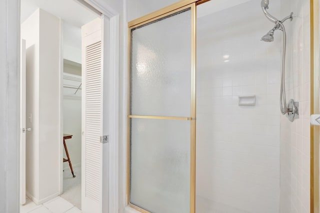 bathroom with tile patterned floors and walk in shower