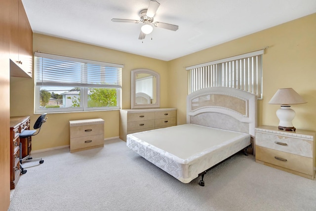 bedroom with light carpet and ceiling fan