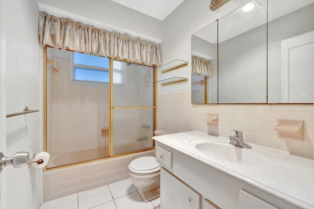 full bathroom featuring vanity, tile patterned flooring, toilet, enclosed tub / shower combo, and tile walls