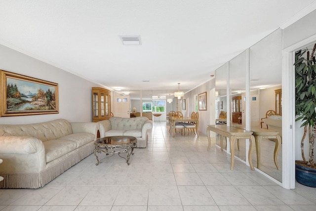 tiled living room with a chandelier and ornamental molding