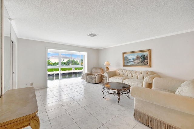 living room featuring light tile patterned floors, a textured ceiling, and ornamental molding