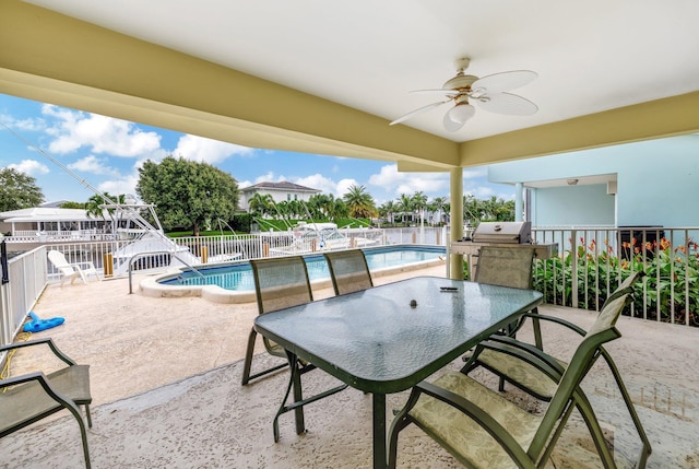 view of patio with grilling area, a fenced in pool, and ceiling fan