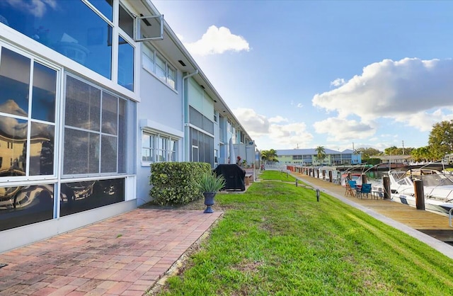 exterior space with a lawn and a dock