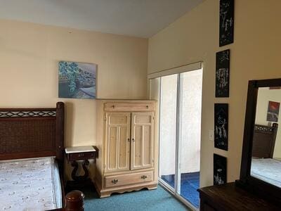 bedroom featuring carpet floors and access to exterior