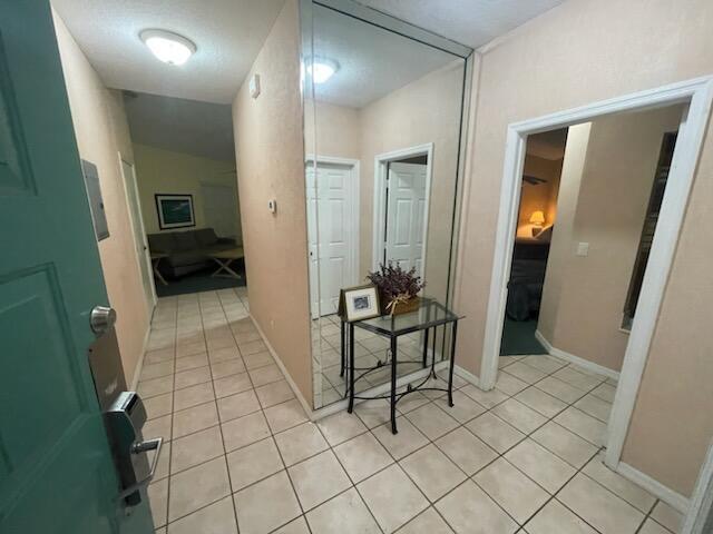 corridor featuring light tile patterned floors