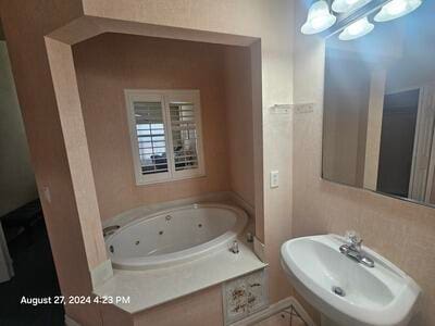 bathroom featuring sink and a tub