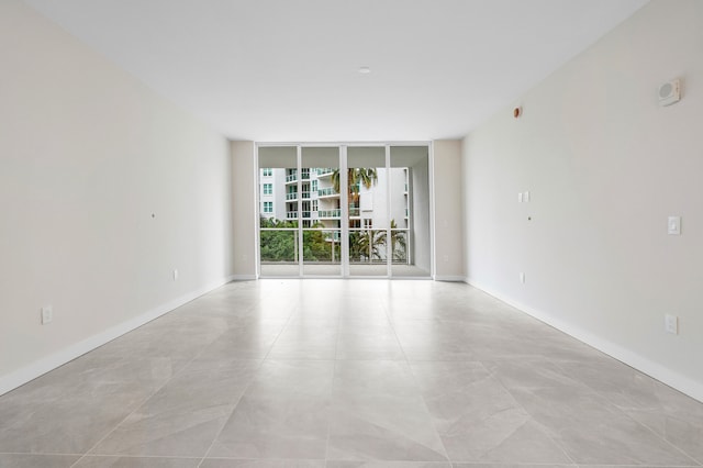 unfurnished room featuring floor to ceiling windows