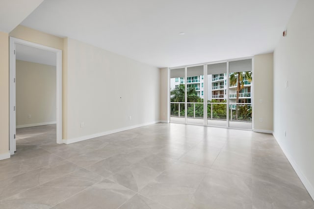 unfurnished room with floor to ceiling windows