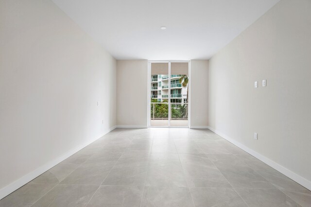 unfurnished room with floor to ceiling windows