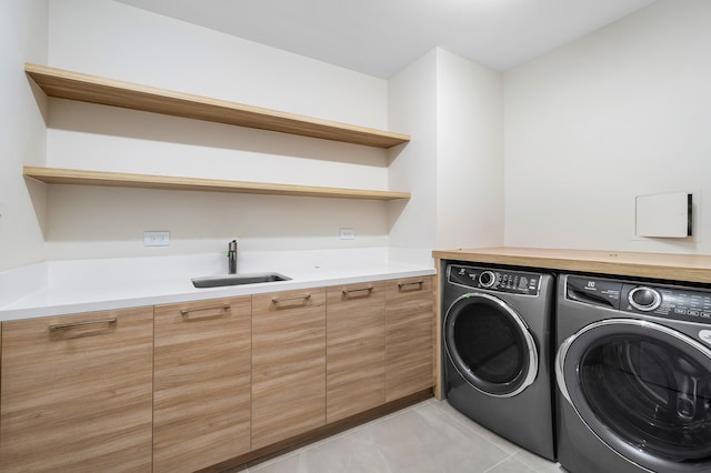 laundry room featuring separate washer and dryer, sink, and light tile patterned flooring