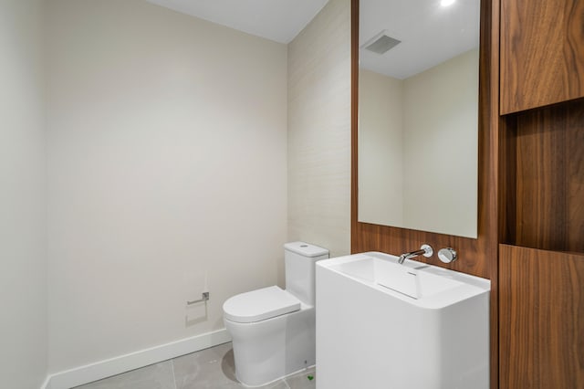 bathroom featuring tile patterned flooring and toilet