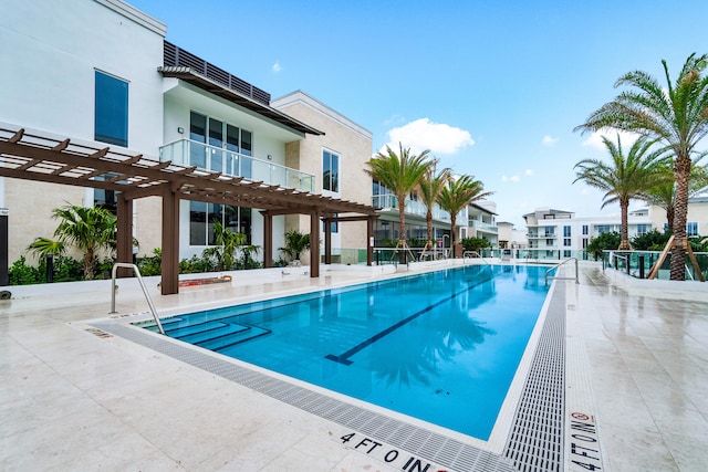 view of pool with a patio and a pergola