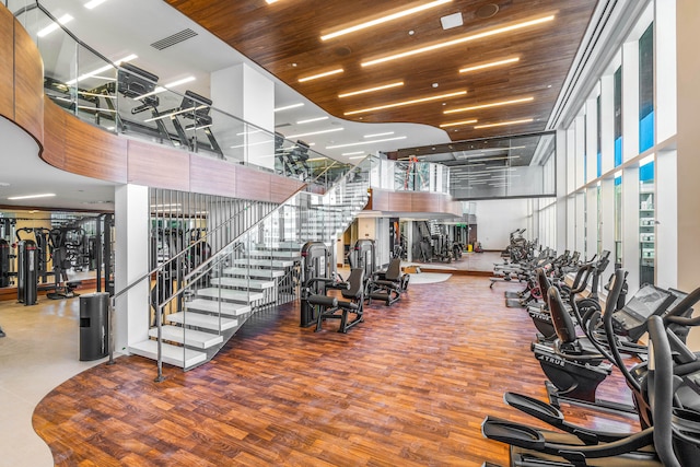 workout area with a high ceiling and hardwood / wood-style floors