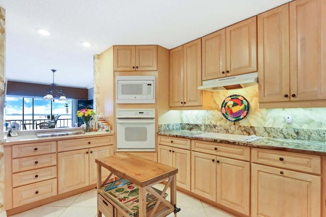 kitchen featuring light brown cabinets, decorative light fixtures, an inviting chandelier, light tile patterned floors, and white appliances