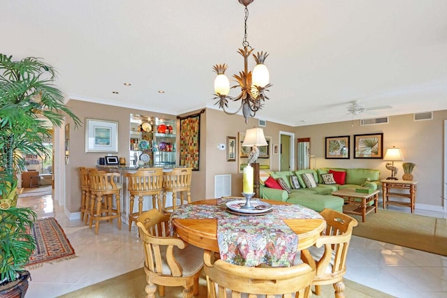 dining space featuring crown molding, light tile patterned floors, and ceiling fan