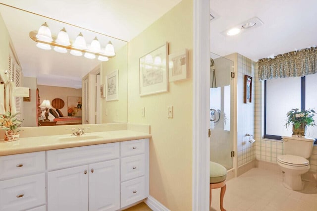 bathroom with vanity, toilet, tile patterned flooring, and an enclosed shower