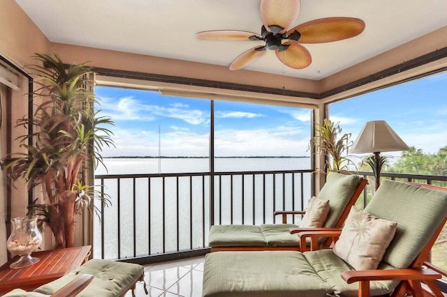 sunroom / solarium with a water view and ceiling fan