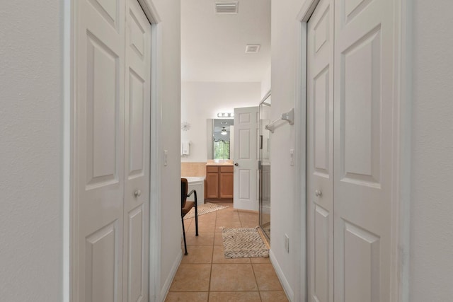 hall with light tile patterned flooring