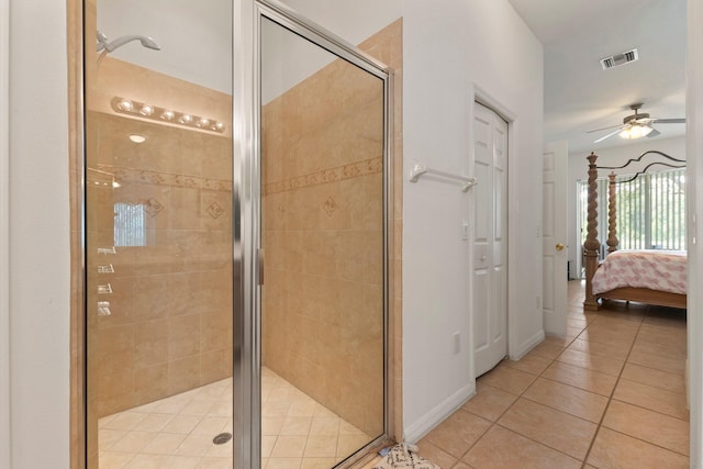 bathroom featuring a shower with door, ceiling fan, and tile patterned flooring