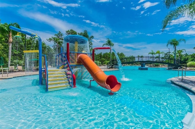 view of pool with a playground