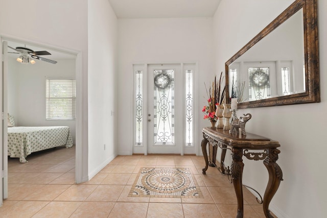 foyer entrance featuring ceiling fan and light tile patterned floors