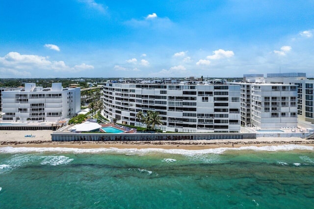 view of property featuring a water view and a beach view