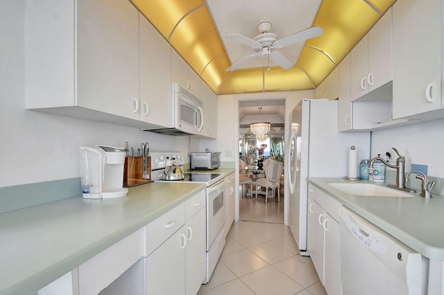 kitchen featuring sink, white cabinetry, and white appliances