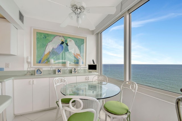 sunroom / solarium featuring ceiling fan