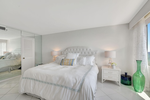 tiled bedroom featuring a closet