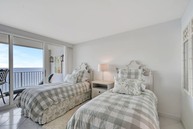 tiled bedroom with a water view and access to outside