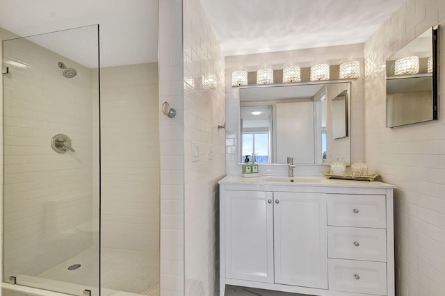 bathroom featuring vanity, tile walls, and tiled shower