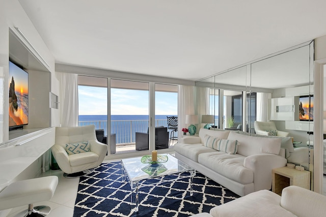 living room with a water view, a healthy amount of sunlight, and a wall of windows