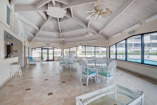 sunroom / solarium with ceiling fan, vaulted ceiling with beams, and wood ceiling