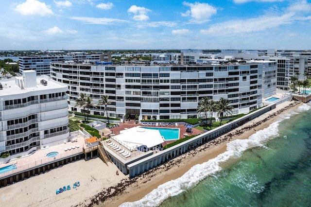 drone / aerial view with a water view and a beach view