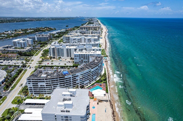 bird's eye view with a water view and a beach view