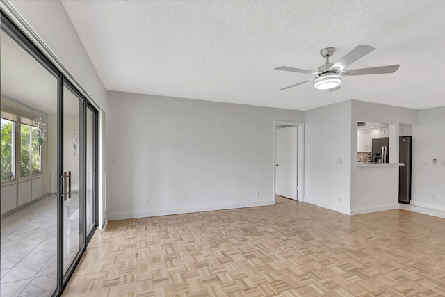 124 Capri C, Delray Beach, FL 33484 - empty room featuring ceiling fan, a textured ceiling, and baseboards