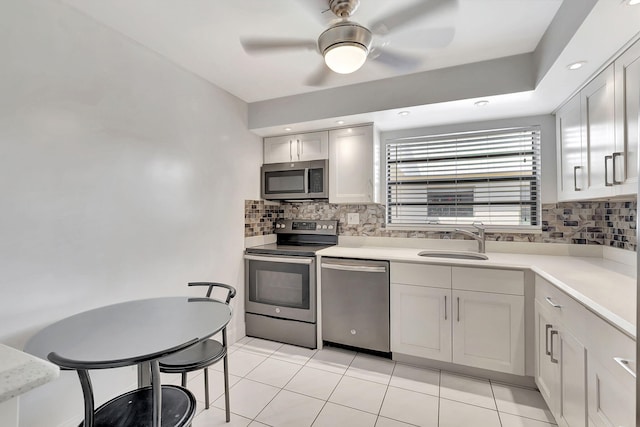 124 Capri C, Delray Beach, FL 33484 - kitchen featuring stainless steel appliances, a sink, backsplash, and a ceiling fan