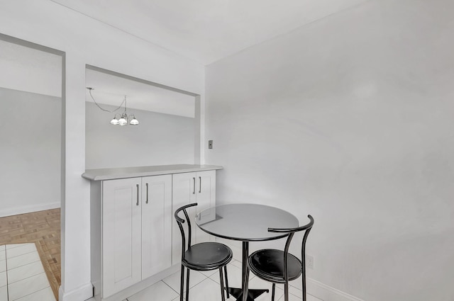 124 Capri C, Delray Beach, FL 33484 - dining space with baseboards and a chandelier