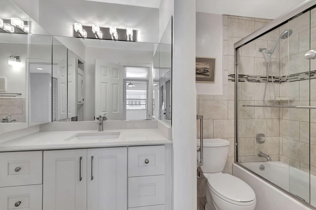124 Capri C, Delray Beach, FL 33484 - full bath with toilet, shower / bath combination with glass door, vanity, and tile walls