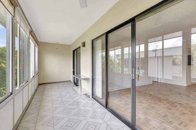 unfurnished sunroom featuring vaulted ceiling and a wealth of natural light