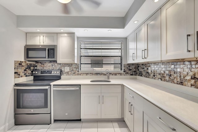 124 Capri C, Delray Beach, FL 33484 - kitchen with appliances with stainless steel finishes, a sink, light countertops, tasteful backsplash, and recessed lighting