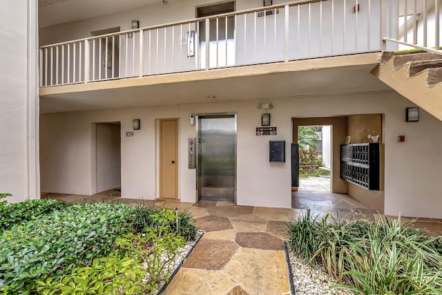 124 Capri C, Delray Beach, FL 33484 - doorway to property with elevator and a balcony