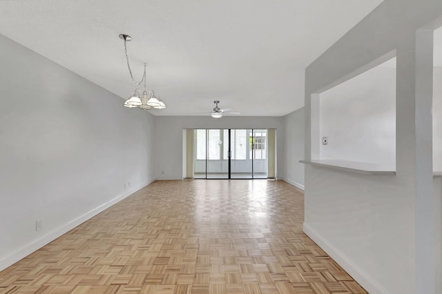 unfurnished room featuring light parquet floors and ceiling fan with notable chandelier