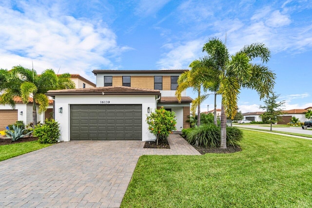 view of front of home with a front lawn and a garage