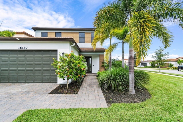 view of front facade with a garage and a front lawn