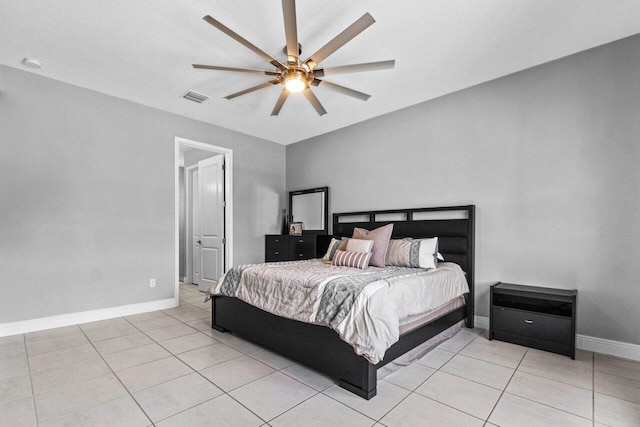 bedroom with a textured ceiling, ceiling fan, and light tile patterned flooring