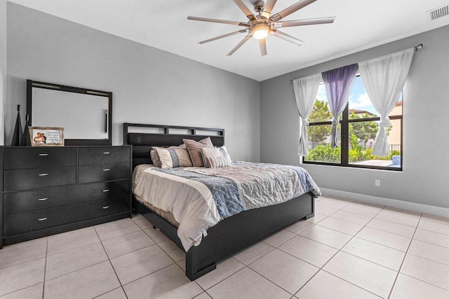 tiled bedroom with ceiling fan