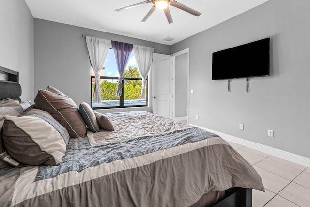 tiled bedroom featuring ceiling fan